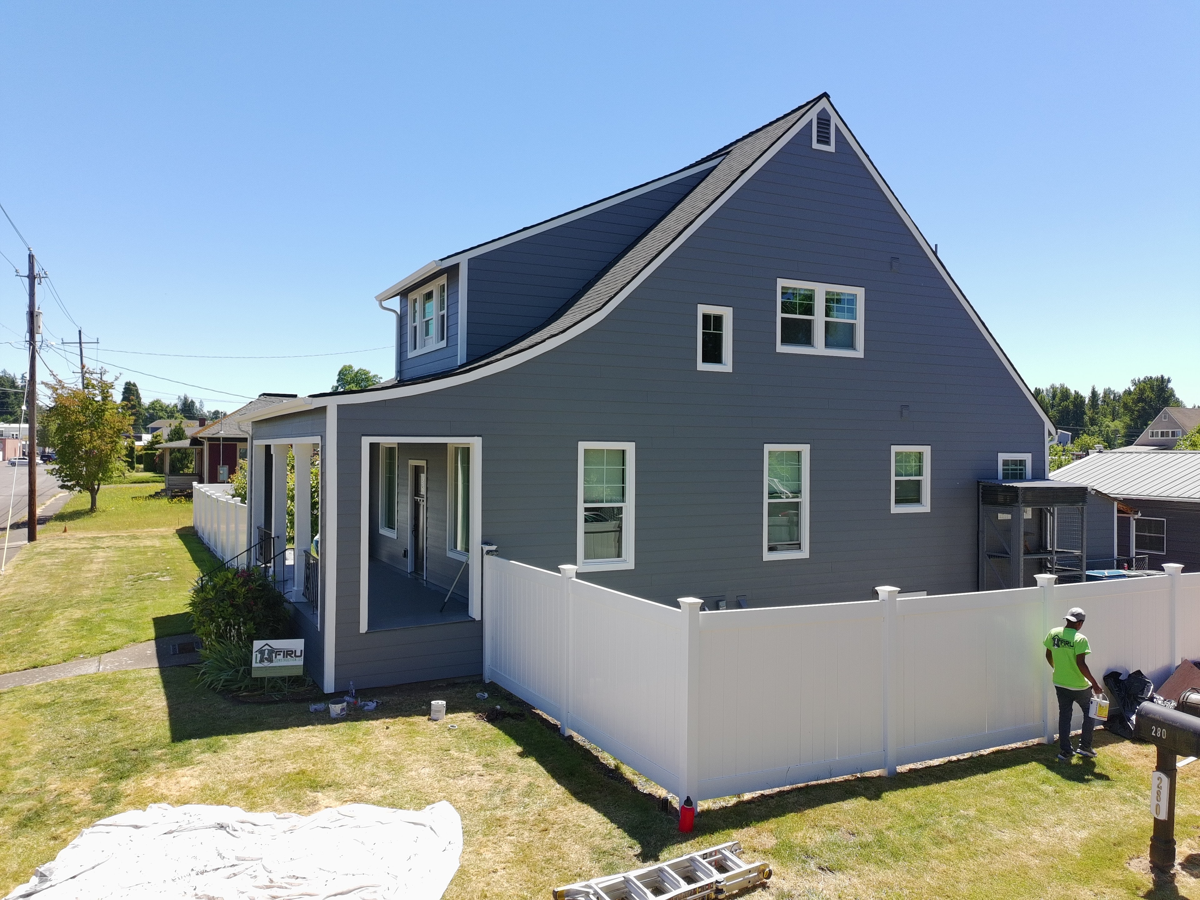 Completed gray James Hardie siding with white trim and front porch — Stayton Oregon